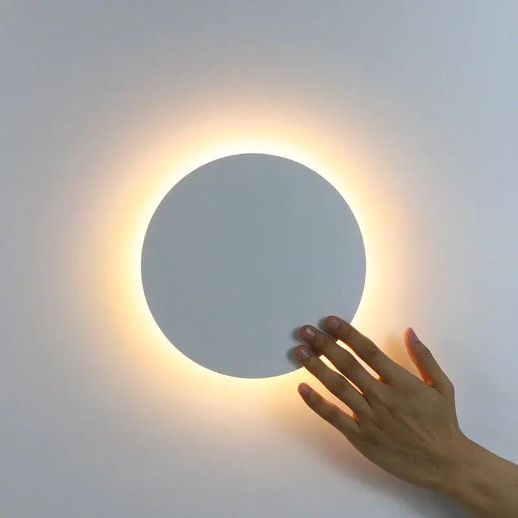 Circular Wall Light with a white circular metal and acrylic design, emitting a warm glow and touch-activated control.
