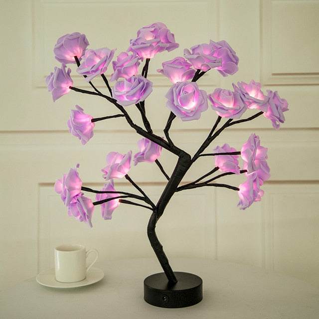 Rose Tree Lamp with black branch structure and glowing soft pink LED rose-shaped petals on a round black base.