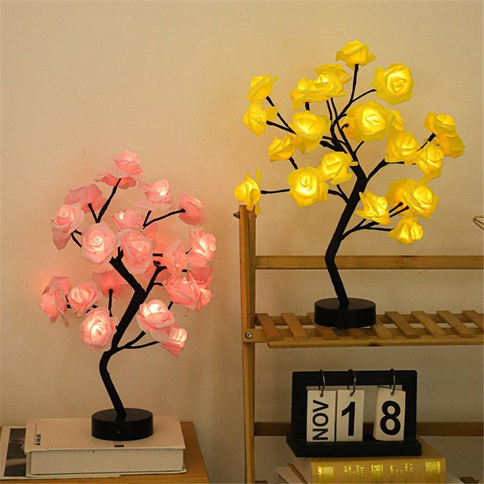 Rose Tree Lamp featuring delicate rose-shaped lights in pink and yellow on black branches with round bases, adding a warm glow.