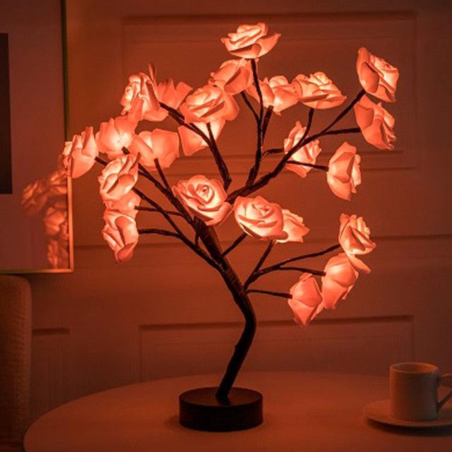 Rose Tree Lamp with warm pink glowing resin rose petals on dark brown branches and a round black base