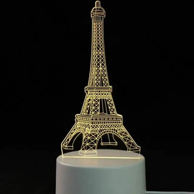 3D LED Lamp shaped like the Eiffel Tower in yellow light with delicate lattice design on a white base