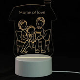 3D LED Lamp with a white base featuring a warm yellow glowing optical illusion of a family sitting on a sofa inside a house outline with &