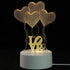 3D LED Lamp with a white base featuring a yellow illuminated optical illusion design of three heart-shaped balloons and the word LOVE