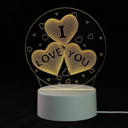 3D LED Lamp with a white base and a yellow glowing 3D optical illusion design of three heart shapes with the words I LOVE YOU