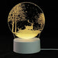3D LED Lamp featuring a white base with a glowing circular panel displaying a tree and deer optical illusion in warm yellow light
