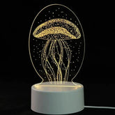 3D LED Lamp with a white base and yellow illuminated jellyfish optical illusion design in a clear oval frame