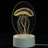3D LED Lamp with a white base and yellow illuminated jellyfish optical illusion design in a clear oval frame