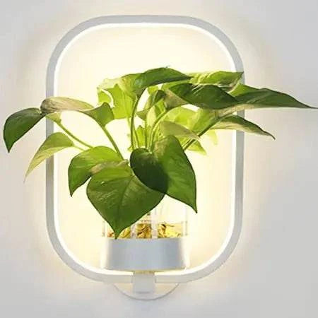 Modern wall plant LED lamp mounted on wall with lush green plant and soft ambient lighting