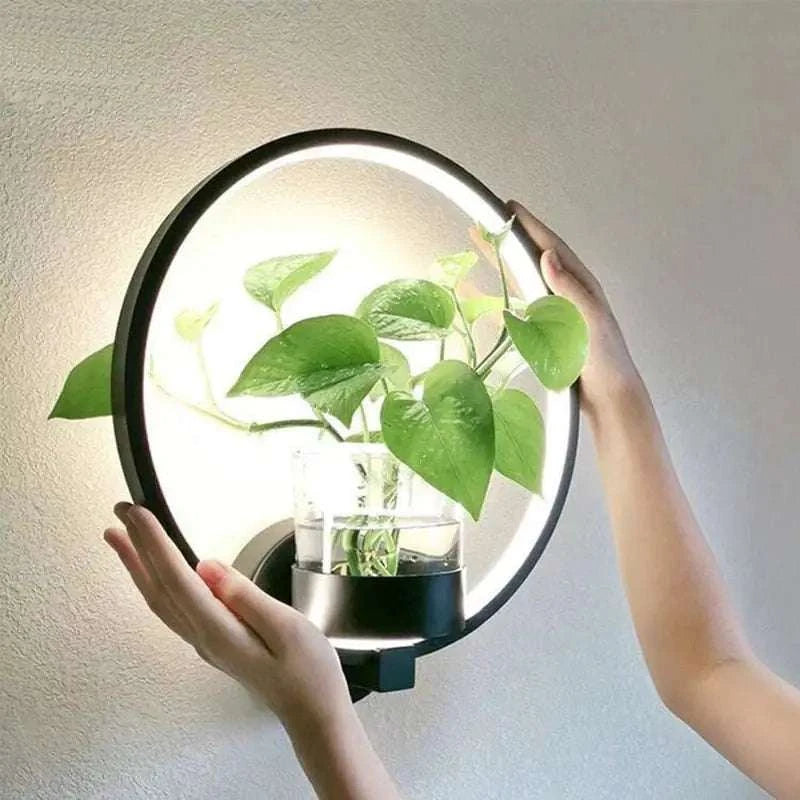 Modern wall plant LED lamp mounted on wall illuminating lush green plants