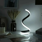Modern LED Spiral Table Lamp with three-speed dimming and USB-powered button switch on a bedside table