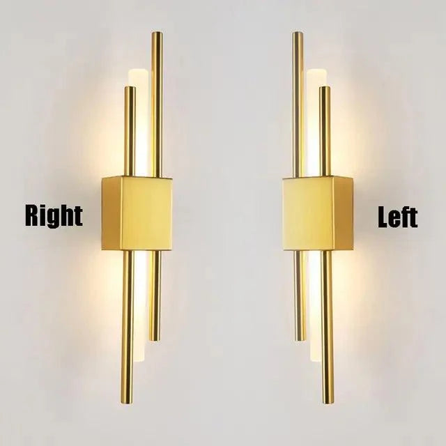 Modern LED wall lamp with sleek iron and acrylic design in gold, emitting warm white light.