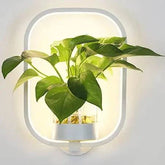 Modern wall plant LED lamp illuminating greenery on indoor wall decor