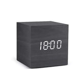 Alarm LED Watch, black wooden cube clock with a bright white digital LED display showing 18:00