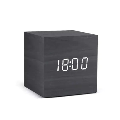 Alarm LED Watch, black wooden cube clock with a bright white digital LED display showing 18:00