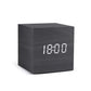 Alarm LED Watch, black wooden cube clock with a bright white digital LED display showing 18:00