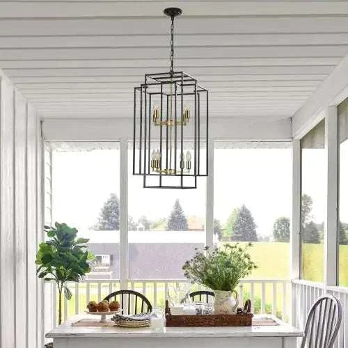 Black & Gold Lantern tiered chandelier with eight lights, black matte iron frame and gold accents hanging above a dining table