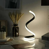 Modern LED Spiral Table Lamp with three-speed dimming and USB-powered switch on a bedroom table