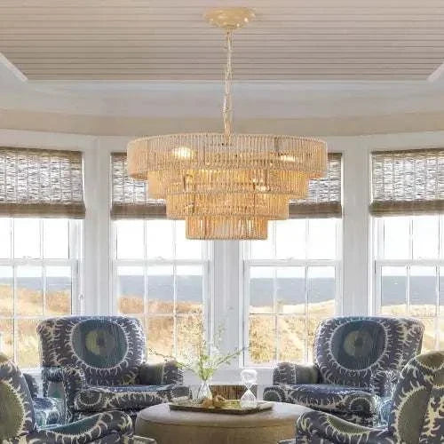 Bohemian Woven Chandelier with layered natural woven rattan design and warm lighting hanging in a bright room with patterned armchairs