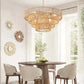 Bohemian Woven Chandelier with natural wood-colored woven rattan, layered circular design hanging above a dining table