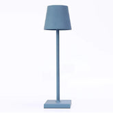 Cordless lamp featuring a sleek blue metal design with a minimalist shade, ideal for stylish modern lighting.