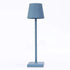 Cordless lamp featuring a sleek blue metal design with a minimalist shade, ideal for stylish modern lighting.