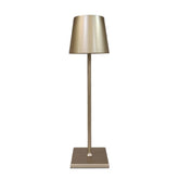 Cordless lamp with a metallic gold finish, sleek design, and minimalist shade on a slim stand and square base.