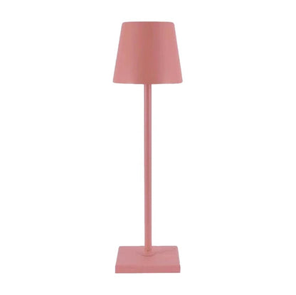 Cordless lamp in muted pink color with a minimalist design, featuring a conical shade and square base.