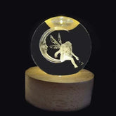 Crystal Night Ball with a clear glass sphere, engraved crescent moon and fairy, on a natural wood base