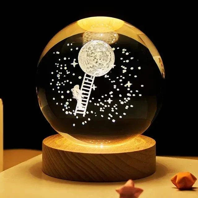 Crystal Night Ball, dark glass sphere with moon, stars and ladder design on a wooden base for ambient lighting