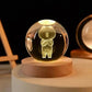 Crystal Night Ball featuring a clear glass globe with bear figurine and warm light on a round wooden base
