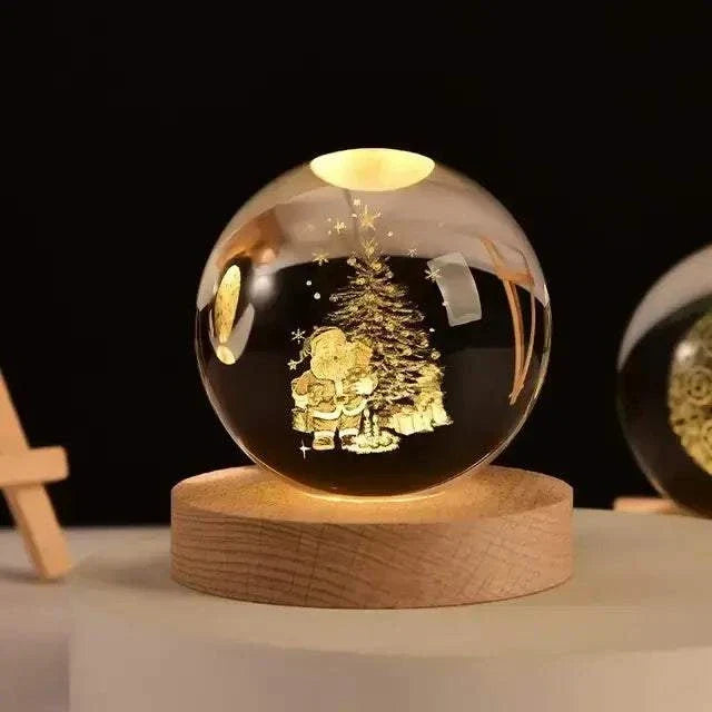 Crystal Night Ball, clear glass sphere with engraved Christmas tree and Santa design on a natural wood base