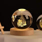 Crystal Night Ball, clear glass sphere with engraved Christmas tree and Santa design on a natural wood base