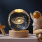 Crystal Night Ball, transparent glass sphere with glowing galaxy pattern on a natural wood base
