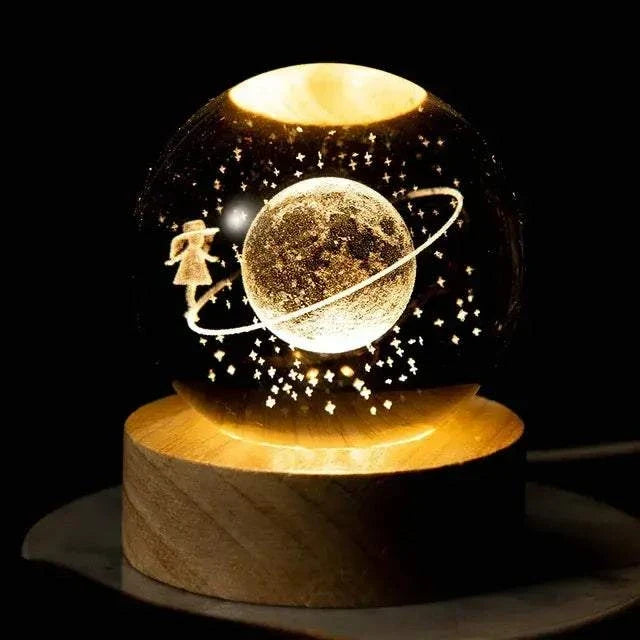 Crystal Night Ball, black glass globe with glowing planet and stars, set on a round wooden base
