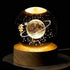 Crystal Night Ball, black glass globe with glowing planet and stars, set on a round wooden base