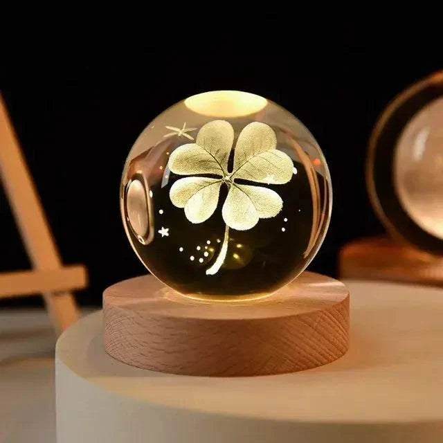 Crystal Night Ball, clear glass sphere with etched flower, stars and crescent moon on a round wooden base