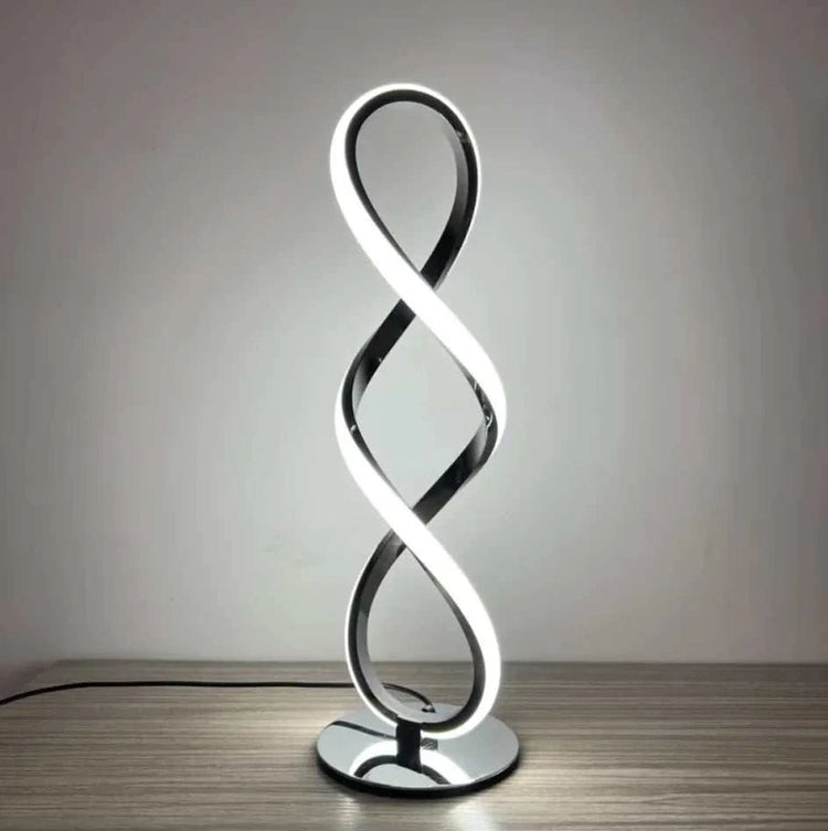 Silver LED table lamp with ambient white and warm light on a modern desk