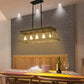 Farmhouse Chandelier with black metal frame and five exposed vintage-style bulbs hanging above a wooden dining table with chairs