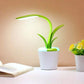 Flower Lamp with green flexible stem and leaves, soft white LED light, in a white flowerpot-style base with built-in USB port