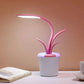 Flower Lamp in white flowerpot with pink curved succulent-like stems and integrated LED light providing soft illumination