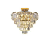 Golden Crystal Chandelier with a gold metal frame and cascading clear crystal tiers in a rounded layered design
