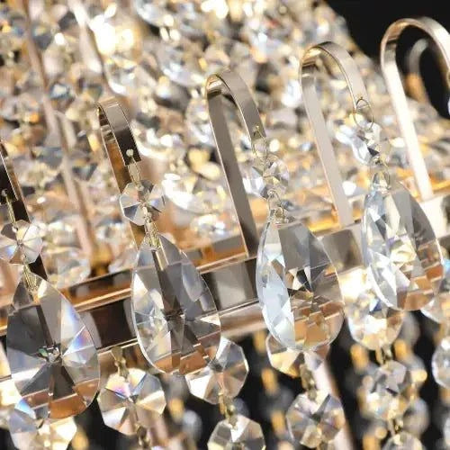 Golden Crystal Chandelier with polished gold metal loops and faceted clear crystal drops in a luxury design