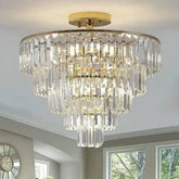 Golden Crystal Chandelier with a gold metal frame and multiple tiers of clear rectangular crystal prisms