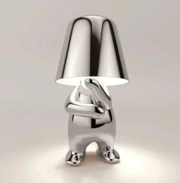 Impression LED Lamp with shiny metallic silver finish and figure-shaped base holding a smooth conical lampshade