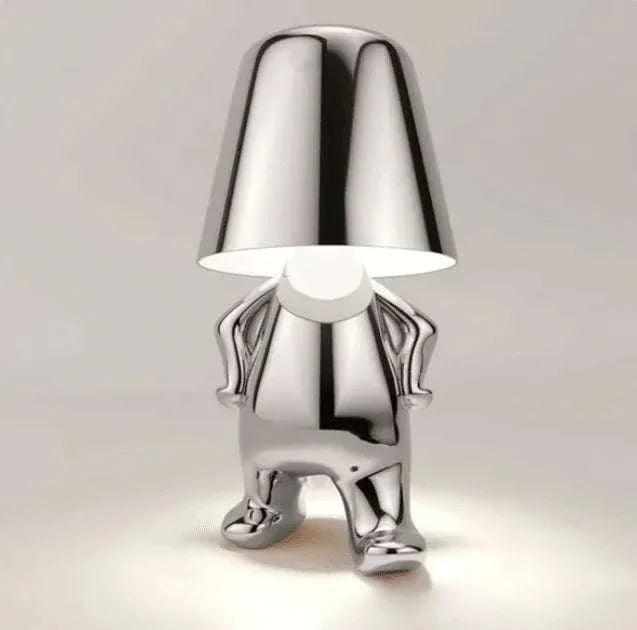 Impression LED Lamp in shiny metallic silver finish, designed as a small humanoid figure with a reflective lampshade head and glowing light beneath it