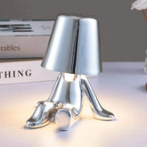Impression LED Lamp with shiny silver metallic finish shaped like a playful dog sitting with a smooth reflective surface