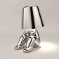 Impression LED Lamp with shiny silver finish featuring a seated humanoid figure design and cone-shaped lampshade