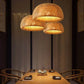 Kuma Bamboo Lamp trio of hanging pendant lights with woven natural bamboo shades emitting warm soft glow