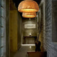 Kuma Bamboo Lamp hanging pendant light featuring natural woven bamboo in warm amber tones, creating ambient illumination