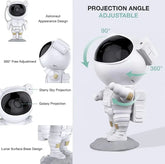 LED Astro Projector shaped like a white astronaut with black helmet, featuring adjustable projection angles and lunar surface base